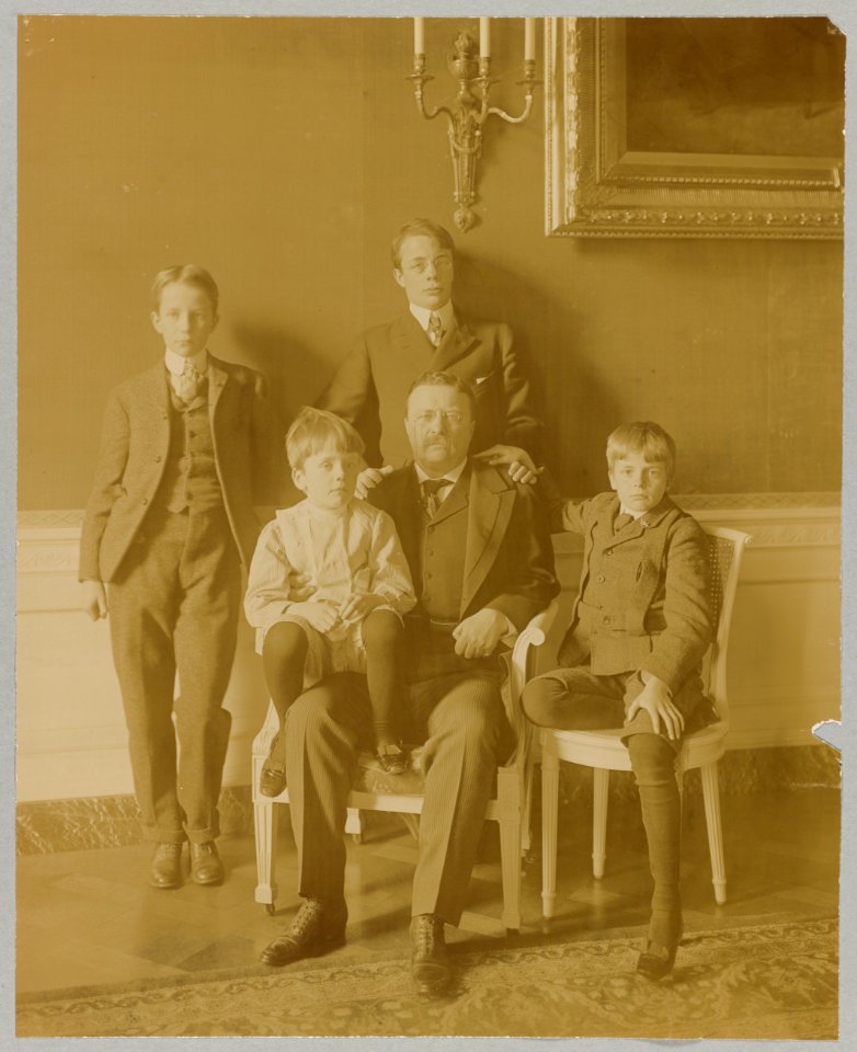 Theodore Roosevelt, full-length portrait, seated, facing front, with his four sons posed around him LCCN92520943