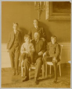 Theodore Roosevelt, full-length portrait, seated, facing front, with his four sons posed around him LCCN92520943