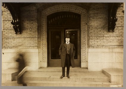 Theodore Roosevelt, full-length portrait, standing, facing front, in front of doorway LCCN2001697250