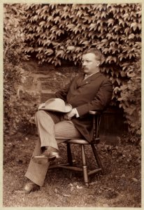 Theodore Roosevelt, full-length portrait, turned left, seated in chair outdoors LCCN2009633160