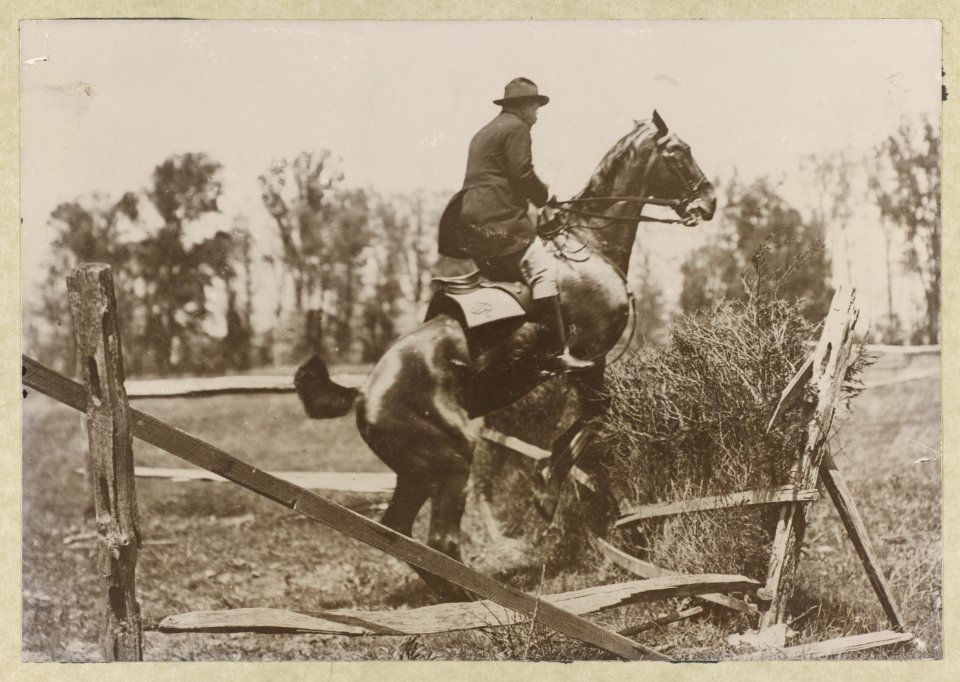 Theodore Roosevelt, side view, on horseback jumping over fence LCCN2013649644