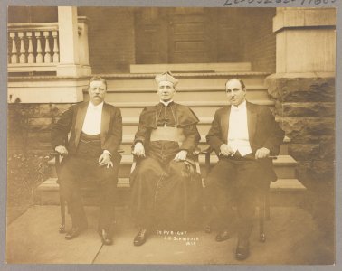 Theodore Roosevelt, Rev. M.J. Hoben (i.e. Hoban), and John Mitchell, posed, seated in front of porch LCCN89712972