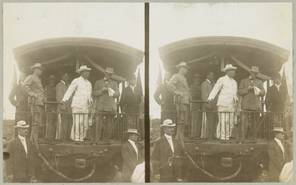 Theodore Roosevelt, standing on back of railroad car, speaking toward crowd LCCN91708855