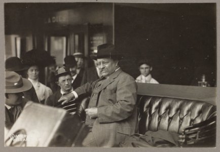 Theodore Roosevelt, three-quarter length portrait, facing left, seated in car or carriage LCCN96511836