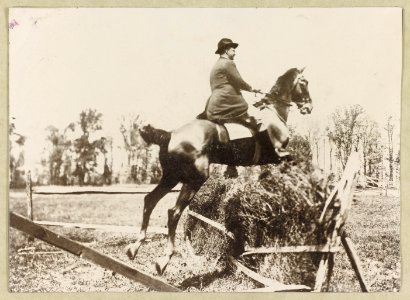 Theodore Roosevelt, side view, on horseback jumping over fence LCCN2013649649