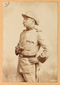 Theodore Roosevelt, three-quarter length portrait, holding a binocular, facing left LCCN2013651053