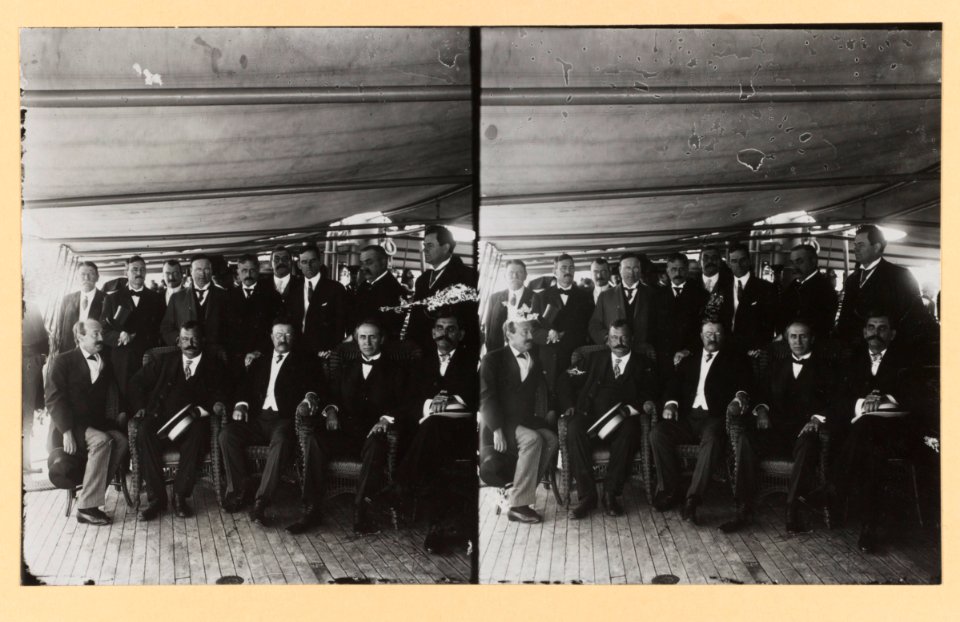 Theodore Roosevelt, seated on deck of ship with group of men, for group portrait LCCN2013650585