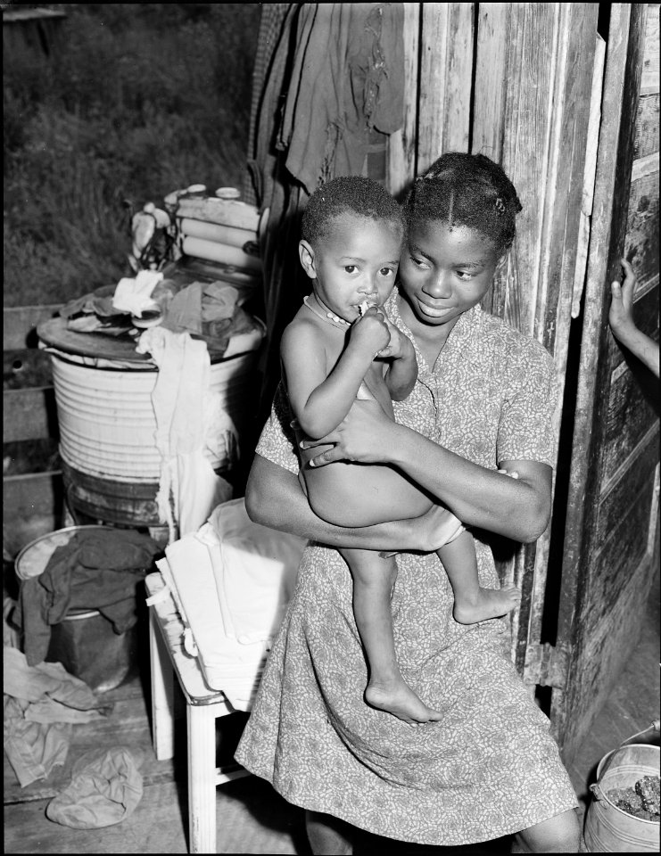 There are ten children in the Lawson Mayo family, the older taking care of the youngest ones. Three of the daughters... - NARA - 540975