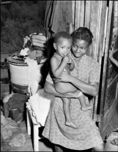 There are ten children in the Lawson Mayo family, the older taking care of the youngest ones. Three of the daughters... - NARA - 540975