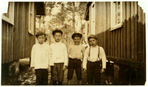 They all shuck oysters at Pass Christian. Boy on left end is George Wikowski, nine years old; next is John Collins; next is Steve Strupeck, who worked last year; on right hand end is Frank LOC nclc.00853