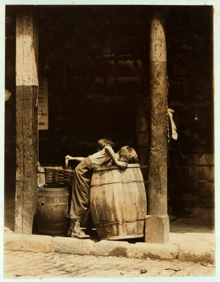 This boy and brother were picking discarded fruit out of barrels in market near 14th St. N.Y. City. He was also (when apparently unobserved) stealing good fruit from their barrels. LOC cph.3b11030