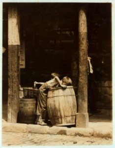 This boy and brother were picking discarded fruit out of barrels in market near 14th St. N.Y. City. He was also (when apparently unobserved) stealing good fruit from their barrels. LOC cph.3b11030