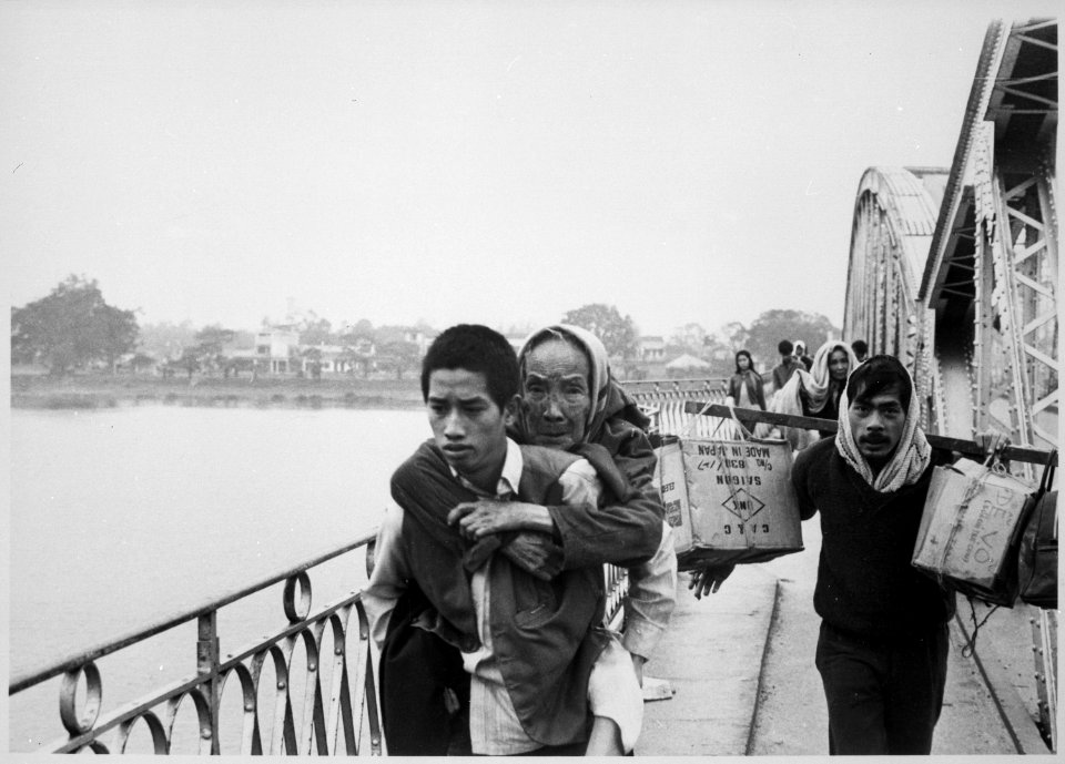 This bridge over the Perfume River in Hue was still standing as these refugees fled across it to escape Tet fighting, bu - NARA - 541869