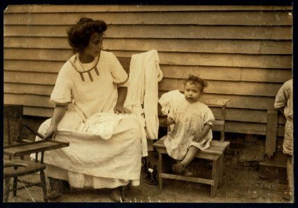 This is typical of the home work on underwear in these quarters. Mother and children and surroundings all filthy. 4 Me Culphe Place, Somerville, Mass. LOC nclc.04244
