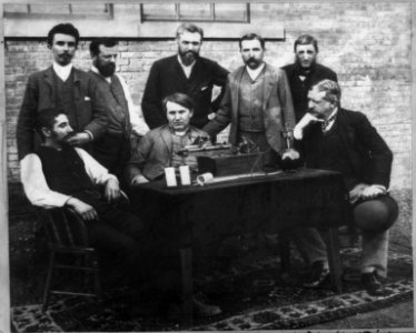 Thomas A. Edison, W.K.L. Dickson, and others at the perfected wax-recording phonograph LCCN2004674420