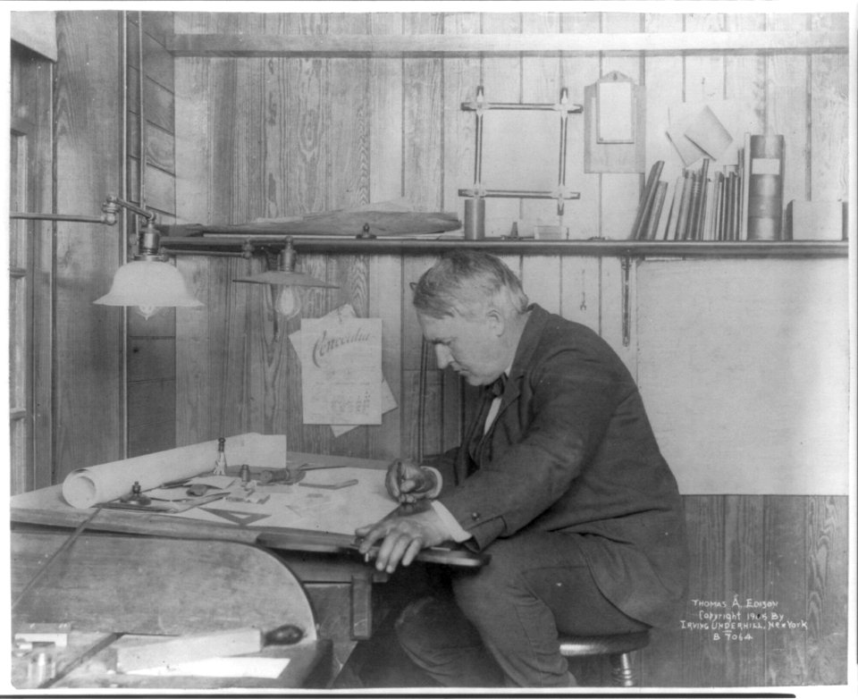 Thomas Alva Edison, 1847-1931, left profile, seated at his desk, writing LCCN2005687287