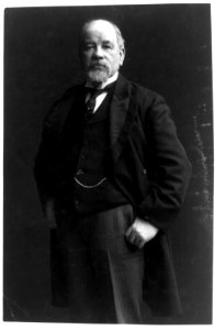 Thomas Burke, candidate to succeed Piles as senator, three-quarter length portrait, standing, facing left, thumbs in his pants pockets LCCN89709231