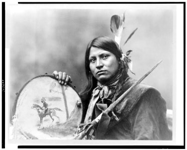 Thomas No Water, head-and-shoulders portrait, facing left, holding tambourine LCCN93504345