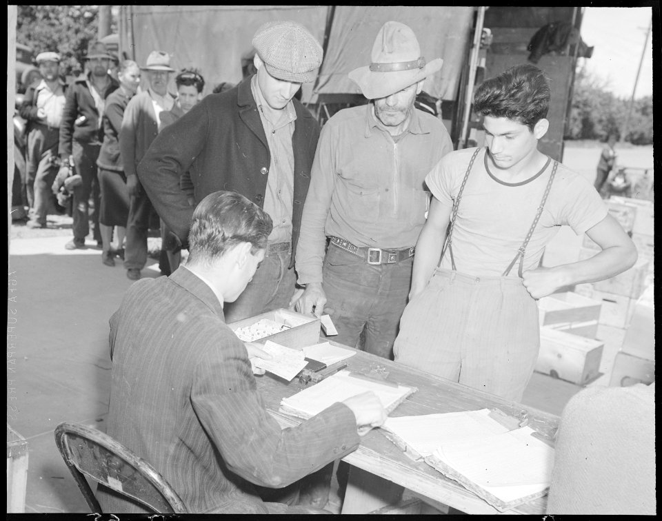 Youth stand in line with oldsters to collect their surplus commodities - NARA - 532128