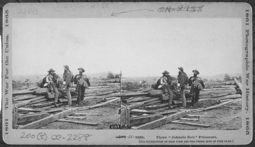 Three Johnnie Reb prisoners captured at Gettysburg. There were hardly two suits alike in a whole regiment, however, a - NARA - 559274