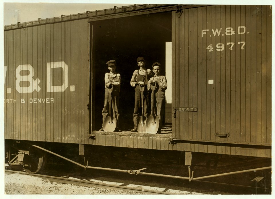 Three Boys Shoveling Zinc Ore from Car Into Wagon, Near Big Bonanza Mine, Aurora, Mo. Youngest boy is Robert Nichols, next larger is Hobart Crawford. They both go to school and work on LOC nclc.01090