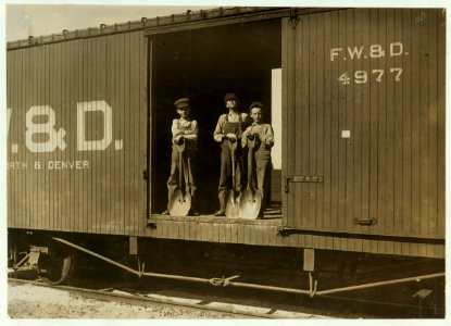 Three Boys Shoveling Zinc Ore from Car Into Wagon, Near Big Bonanza Mine, Aurora, Mo. Youngest boy is Robert Nichols, next larger is Hobart Crawford. They both go to school and work on LOC nclc.01090