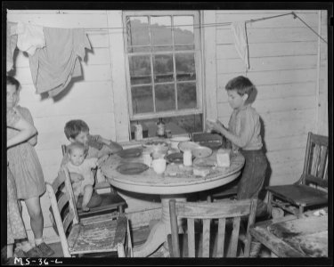 Three children of Ray Ruiexline, miner, eating in kitchen of home. House consists of 4 rooms, one used as kitchen... - NARA - 540232