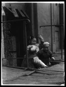 Three children in front of a cellar door, Chinatown, San Francisco LOC agc.7a55031