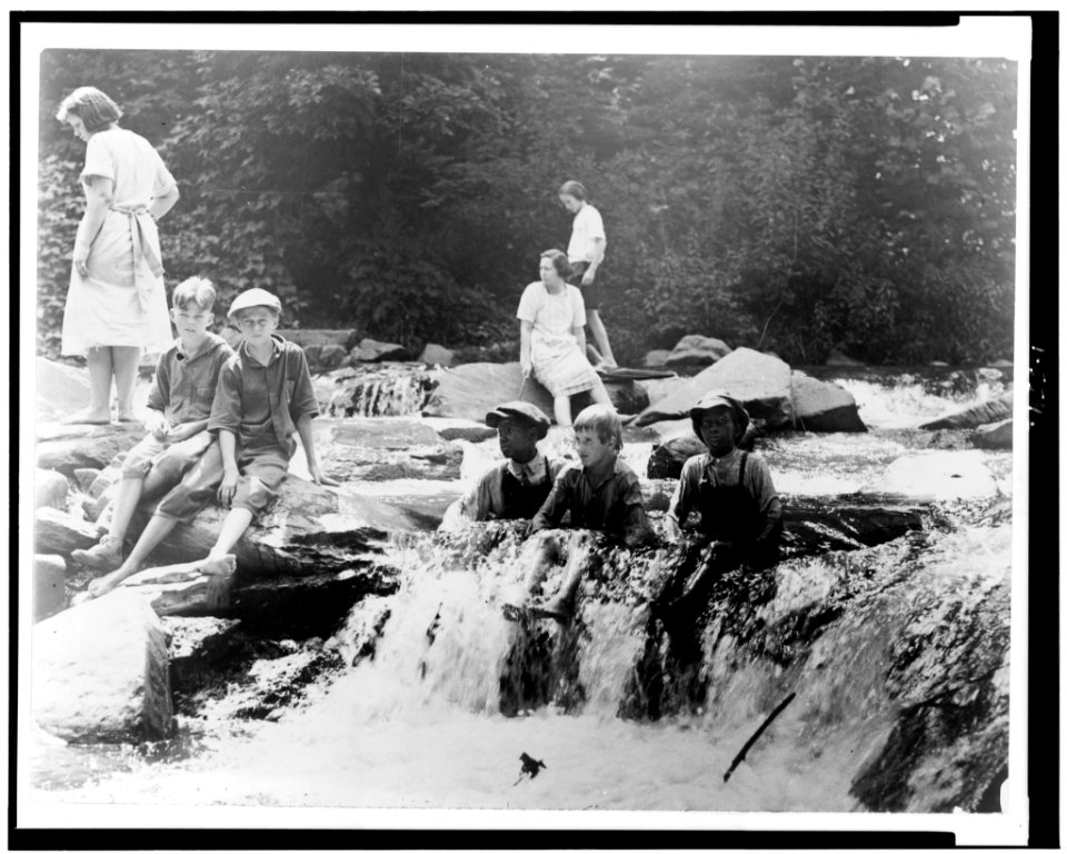 Three boys seated in creek, and three girls and two boys on rocks in Rock Creek, Washington, D.C. LCCN92513237