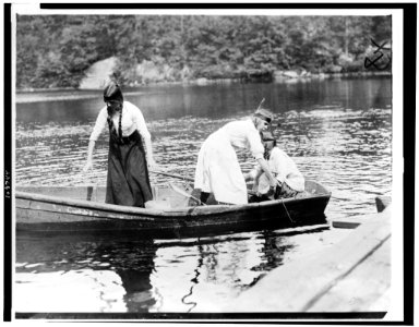 Three Girl Scouts in boat at a camp LCCN94501677