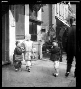 Three children standing on a sidewalk, Chinatown, San Francisco LOC agc.7a09021