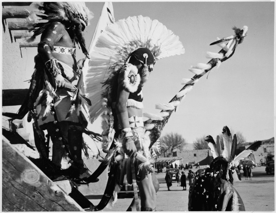Three Indians in headdress in foreground watching tourists, Dance, San Ildefonso Pueblo, New Mexico, 1942., 1942 - NARA - 519979
