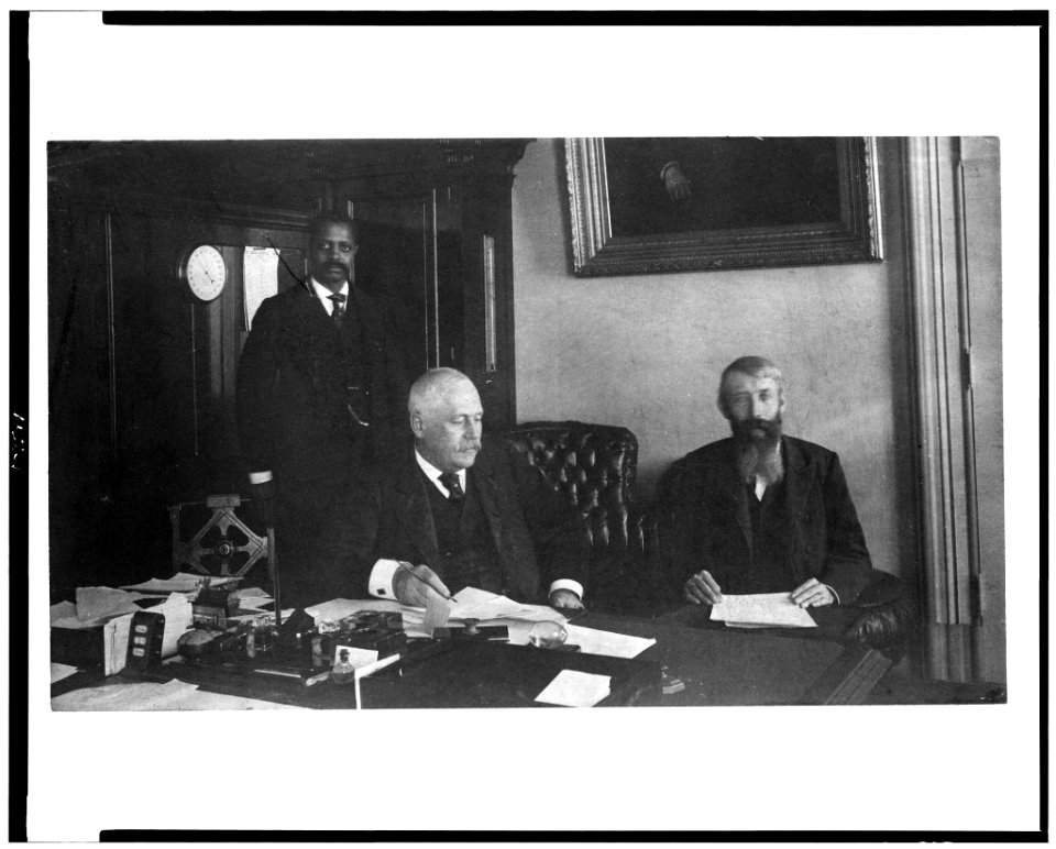 Three men in office in Bureau of Engraving and Printing, Washington, D.C. LCCN93504003