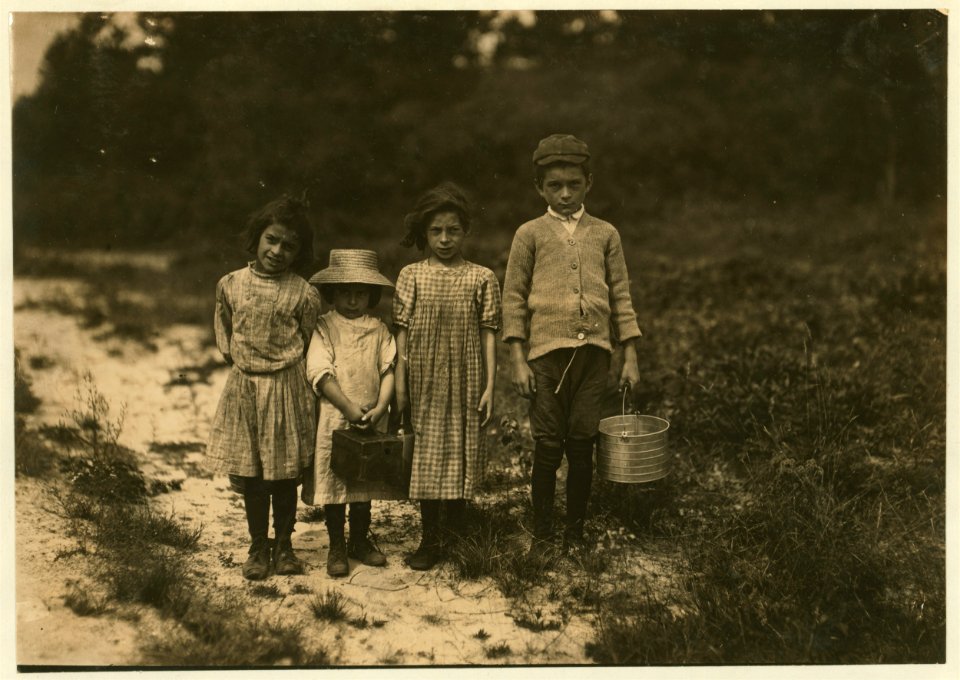 Three pickers going home from work. Anne Benotte, said 7 years old. Brother Vincent said 11. Vincent picked last year. Inez, sister said 6 years old, 'and picked last year wid me mudder.' LOC cph.3a15212