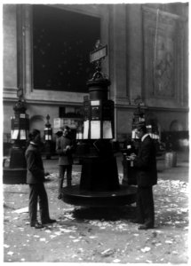 Three men at stock quotations kiosk in stock exchange LCCN92519212 photo