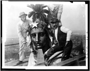 Three men with Statue of Freedom on top of the U.S. Capitol LCCN91792194