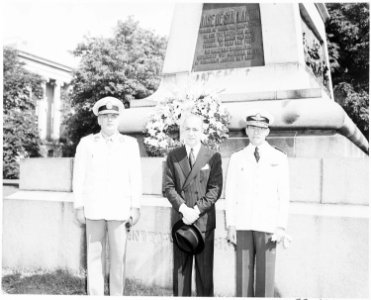 Three men, probably Latin American officials, standing in front of an equestrian statue of Jose de San Martin... - NARA - 199873 photo