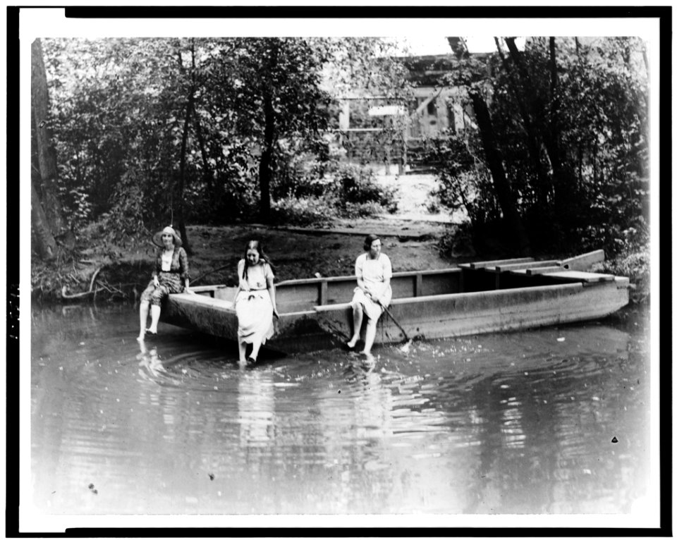 Three women sitting on scow in Rock Creek Park, Washington, D.C. LCCN92513228