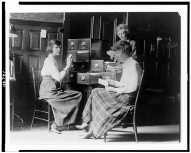 Three women work at the card index files at the headquarters of the National Woman's Party in Washington, D.C. LCCN95502385