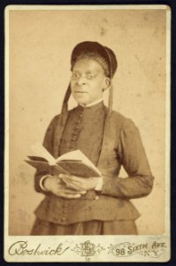 Three-quarter length portrait of an African American woman posed with book) - Bostwick, 98 Sixth Ave., N.Y LCCN2010645141