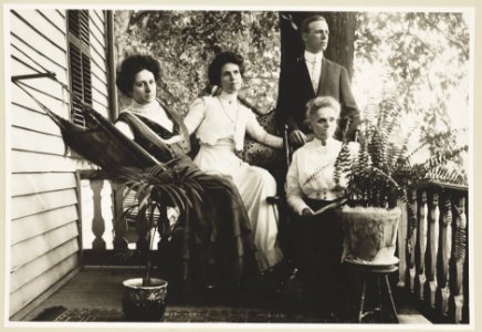 Three women and a man posed on a porch in Vienna, Va. LCCN2010651168