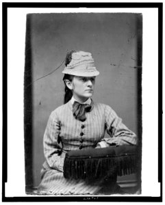 Three-quarter length portrait of a woman seated, wearing a flower pot hat LCCN2006689629 photo