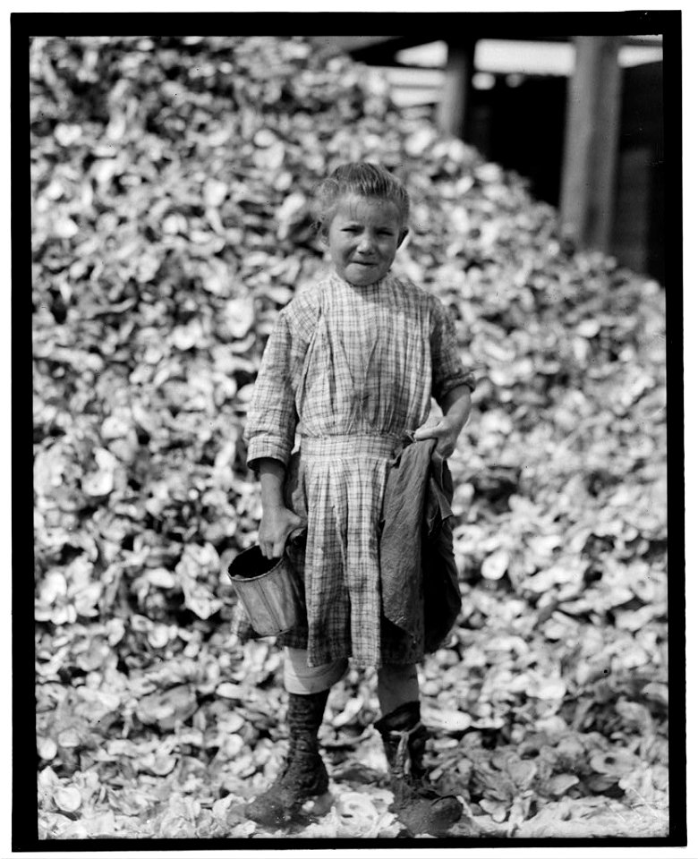Tiny, seven year old oyster shucker (Henry's sister, No. 3291) does not go to school. Works steady. Been at it one year. Maggioni Canning Co. LOC nclc.05335