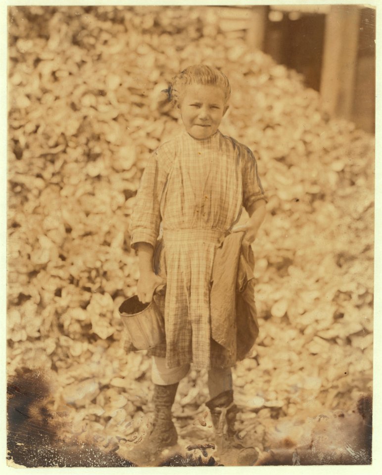 Tiny, seven year old oyster shucker (Henry's sister, No. 3291) does not go to school. Works steady. Been at it one year. Maggioni Canning Co. LOC nclc.05335