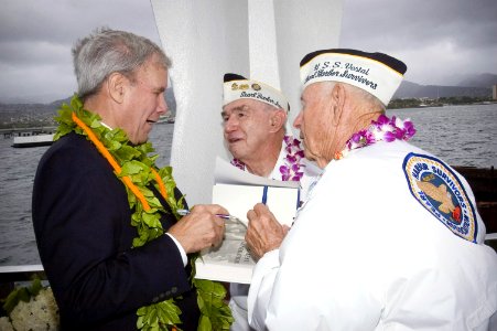 Tom Brokaw gives his autograph to Pearl Harbor survivors