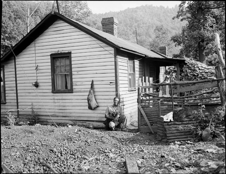 Tommy Howell, miner, beside his three room house for which he pays $7 monthly. Kingston Pocahontas Coal Company... - NARA - 540712