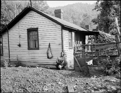 Tommy Howell, miner, beside his three room house for which he pays $7 monthly. Kingston Pocahontas Coal Company... - NARA - 540712
