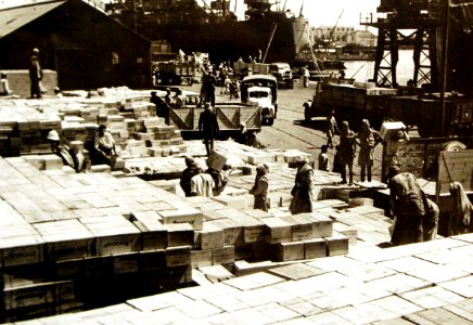 Tons of bully beef being loaded into trucks along dock, Lend-Lease supplies, Middle East, 1942 (24630017599)