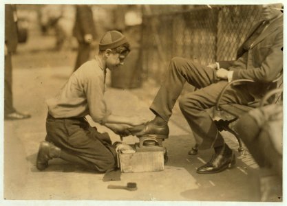 Tony, a twelve year old bootblack at his station in Bowling Green, New York City. He says he makes from $2. to $3. a day regularly. July 25, 1924. LOC nclc.04037
