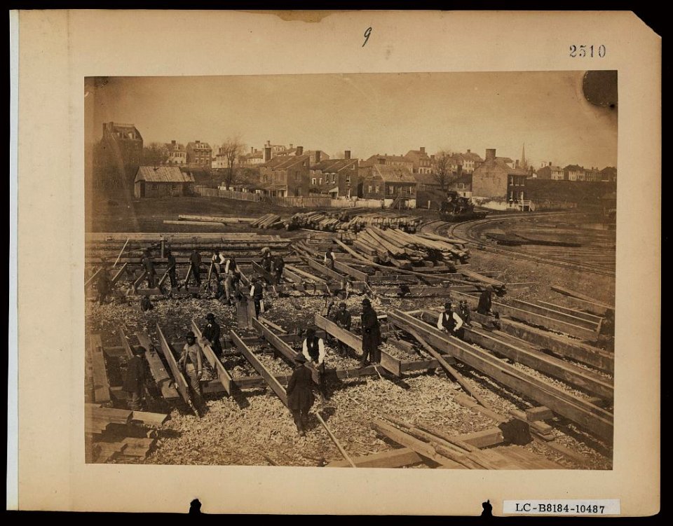 Track near the Potomac River, in Alexandria. Lumber; part of construction force at work, &c LCCN2005696801